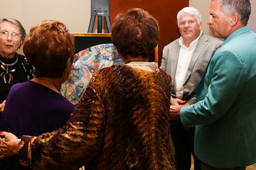 Guests crowded around to see the painting.