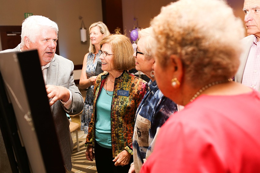 Guests approached the painting to ask questions.