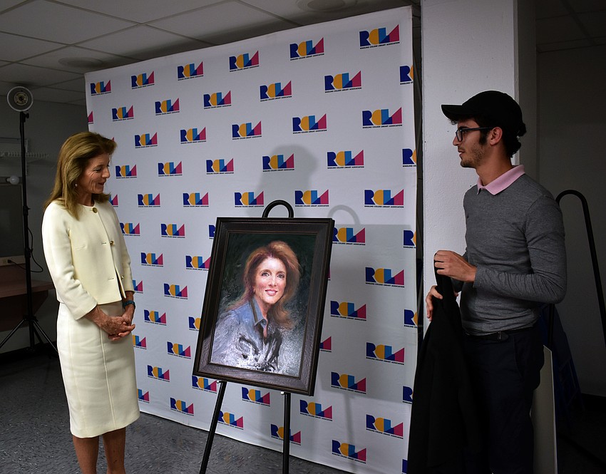 Ringling College of Art and Design junior Kevin Cuellar unveils his portrait of Caroline Kennedy.