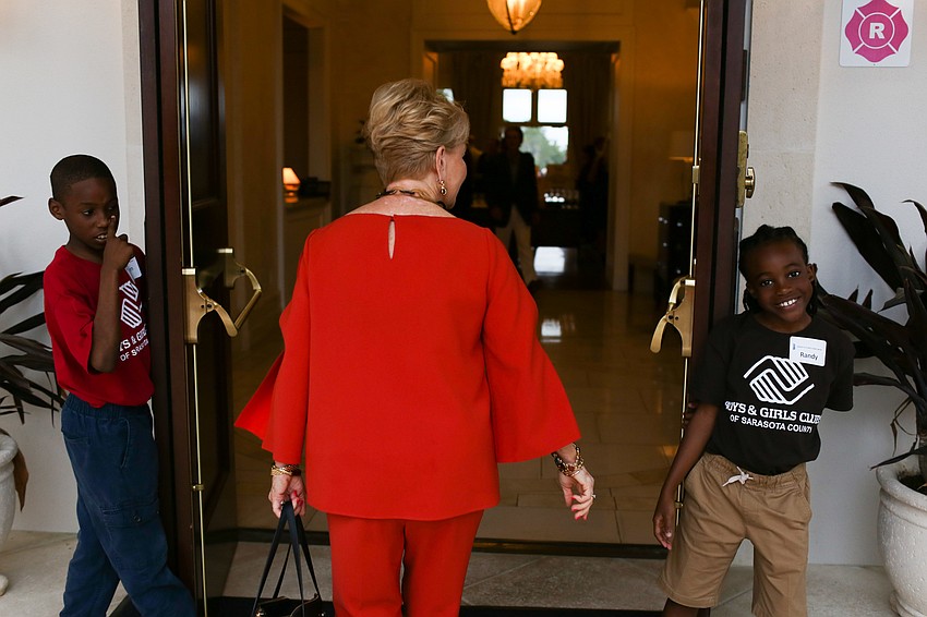Kids from the Boys and Girls Clubs of Sarasota County held doors as guests walked inside.