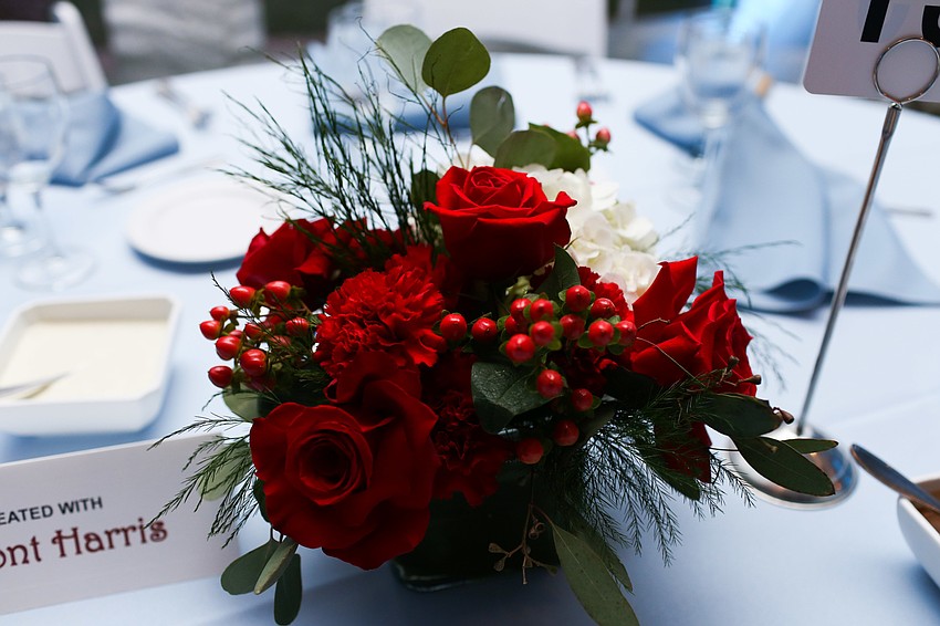 Red and white flowers adorned the baby blue tables.