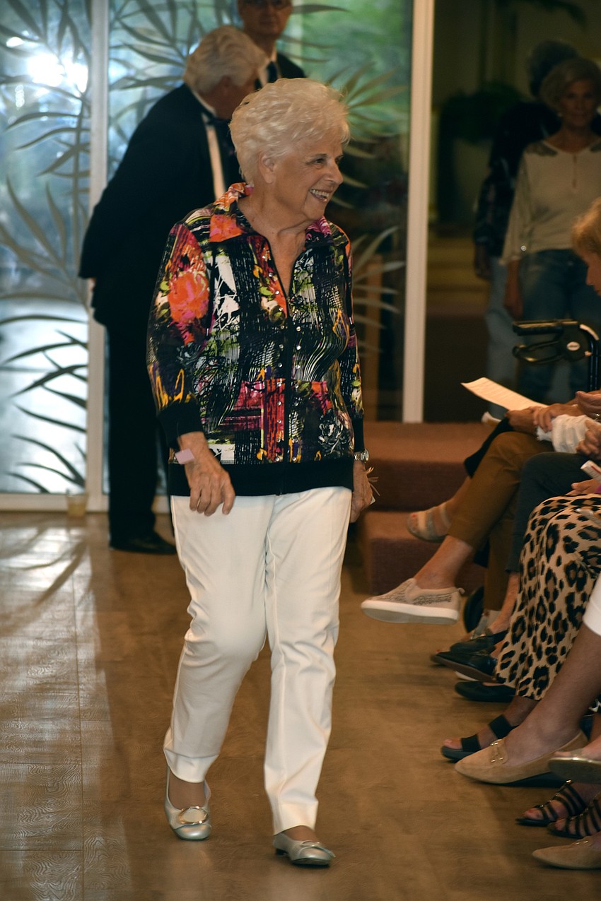 Beryl Schwarztrauber dons a colorful jacket and white pants for the fashion show.