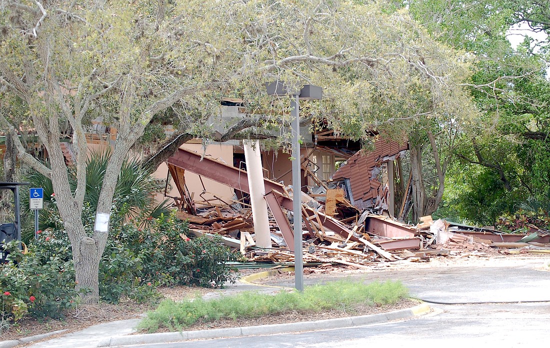 Demolition of the former Amore Restaurant and the clearing of the wooded property is being paid for by a $400,000 county grant.