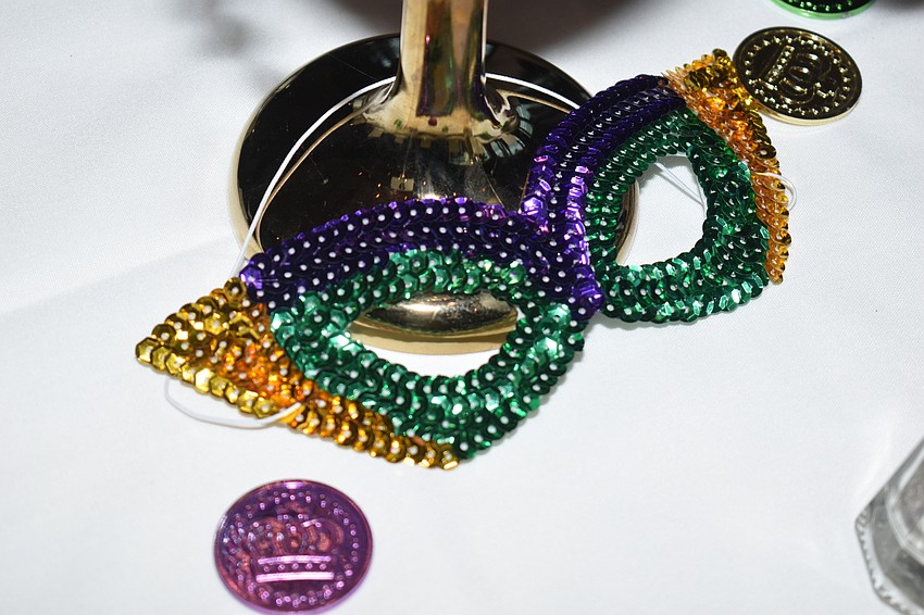 Mardi Gras masks, beads and coins decorated the table.