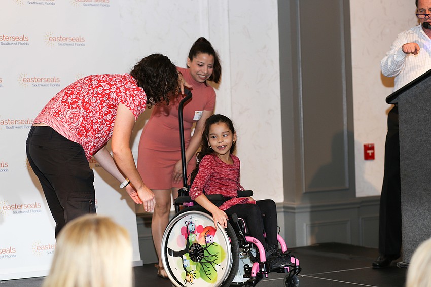 Izzy shows guests her new wheelchair.
