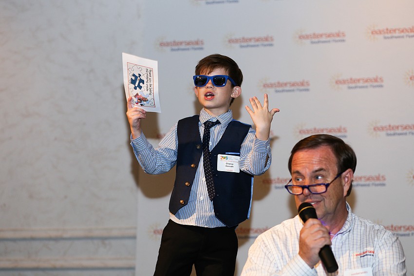 Michael Klauber had a dedicated helper during the live auction and paddle raise.