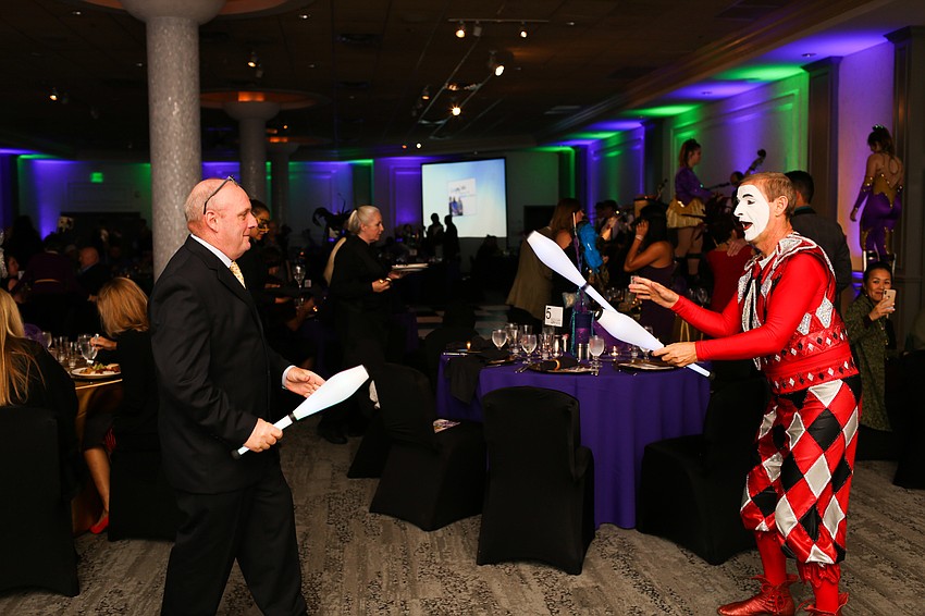 Bill Quaid catches a bowling pin from the Harlequin.