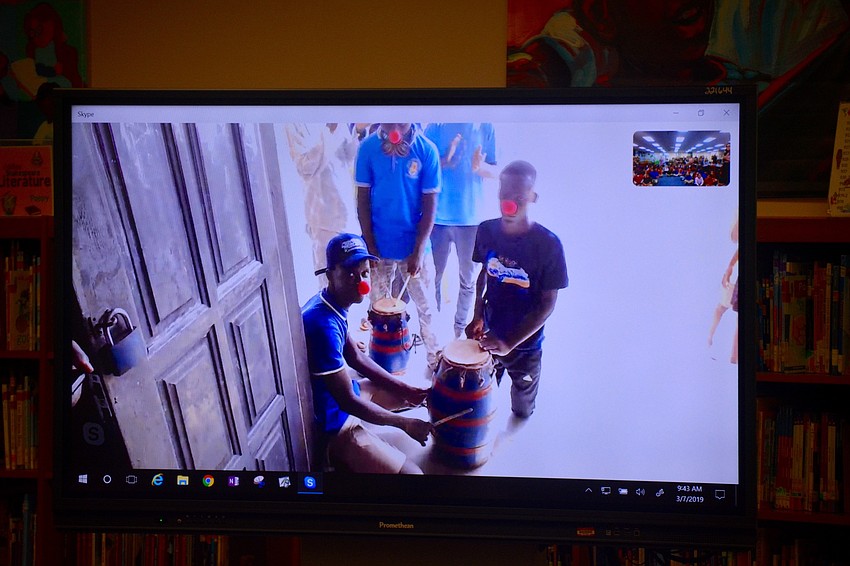 The students in Ghana performed a traditional dance with drums to demonstrate their culture.