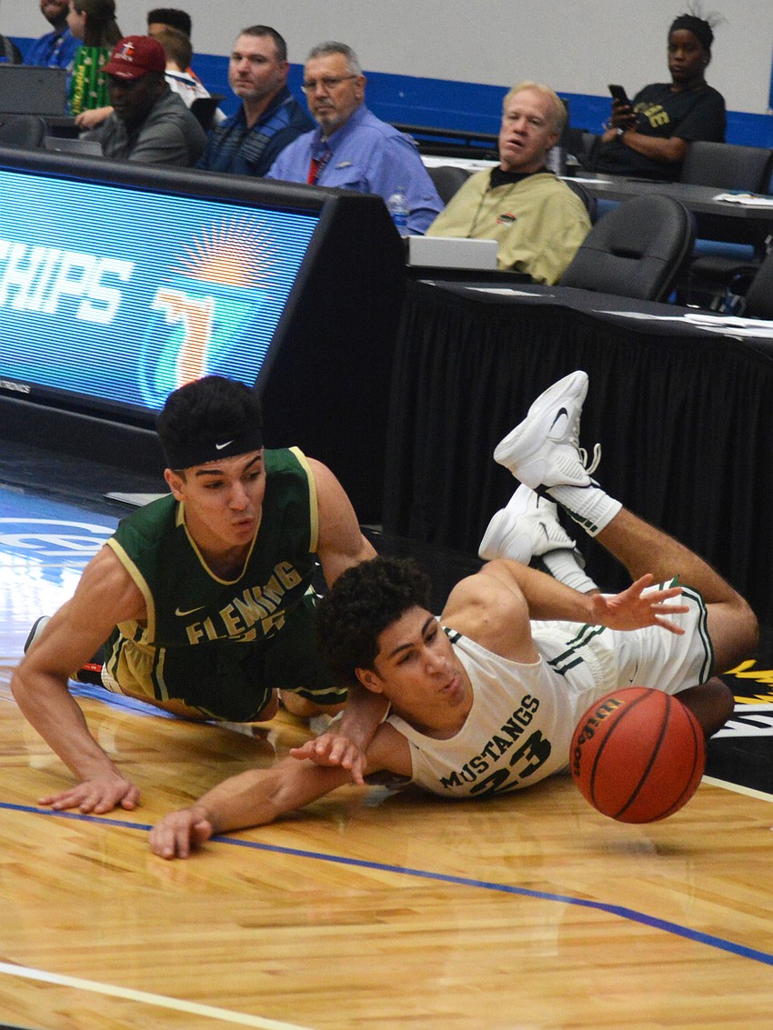 Christian Shaneyfelt dives for a ball in front of Fleming Island's Gianfranco Grafals.