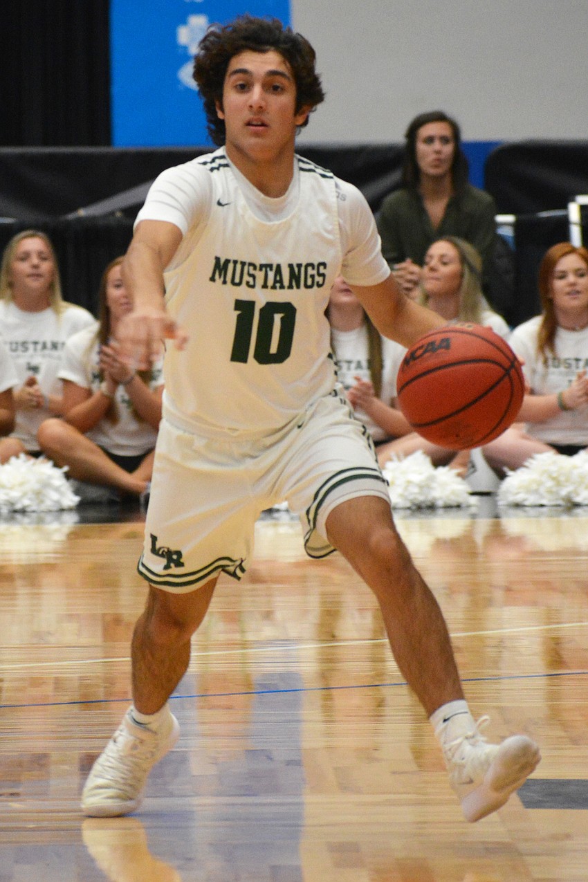 Christian Perez dribbles up the floor against Fleming Island.
