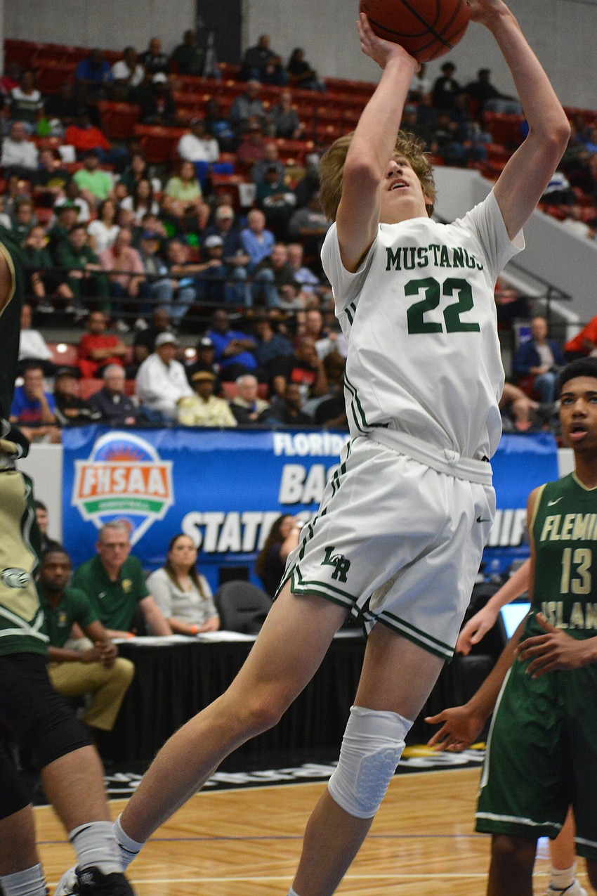 Luke Lecroy leaps in the lane for an inside bucket against Fleming Island.