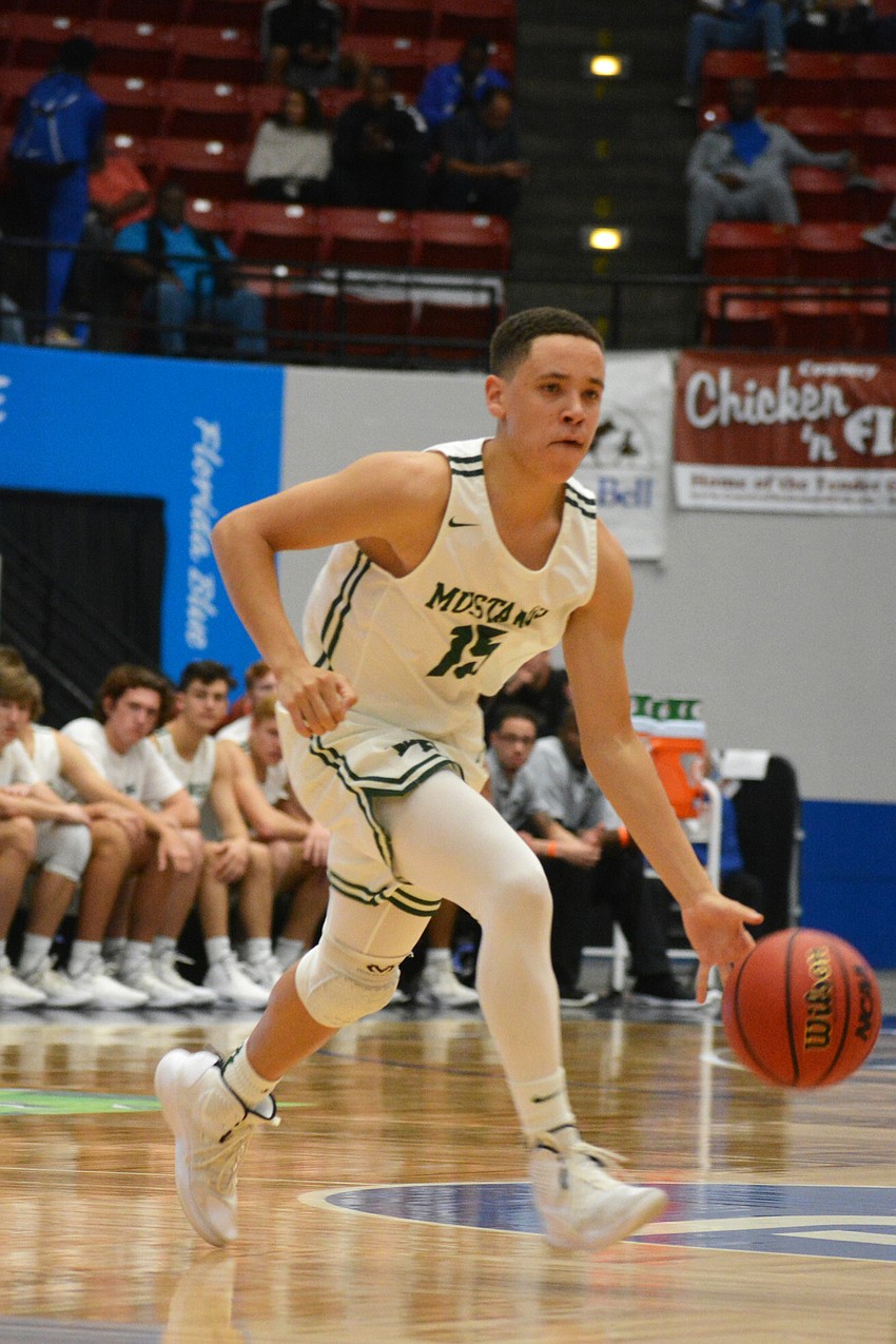 Jaden Jones leads the Mustangs up the floor against Fleming Island.