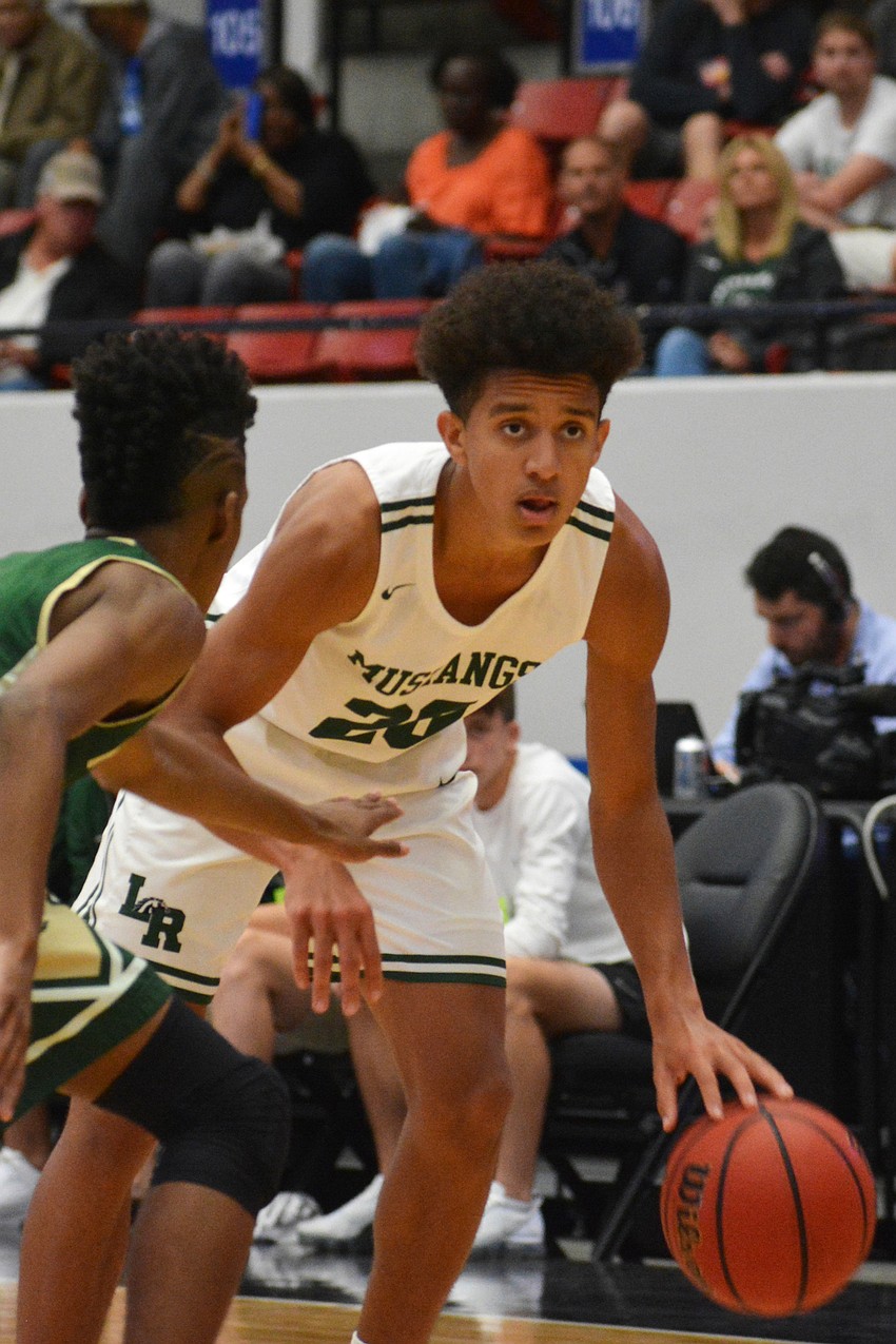 Keon Buckley scans the floor for a teammate against Fleming Island High.