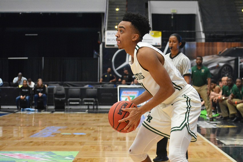Lantz Barton readies for a 3-point attempt in the corner against Fleming Island High.