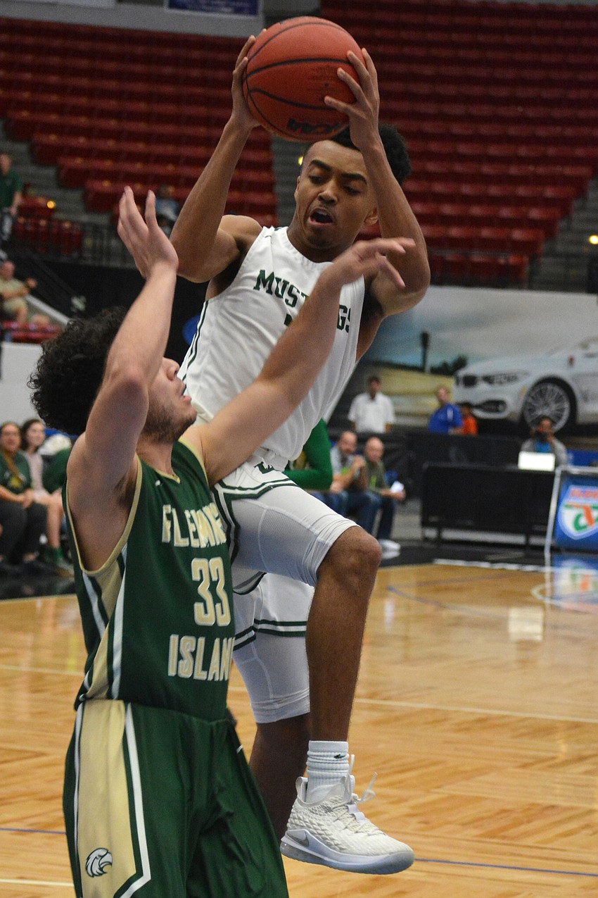 Lantz Barton gets fouled by Fleming Island's Armando Naar.