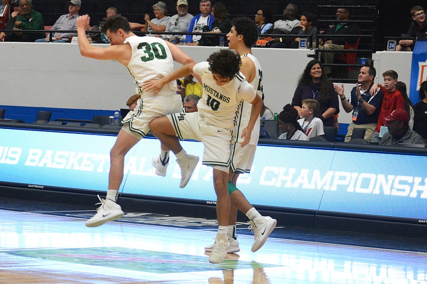 Maxwell Corsiglia (30), Christian Perez (10) and Christian Shaneyfelt celebrate on the court after Lakewood Ranch's win.
