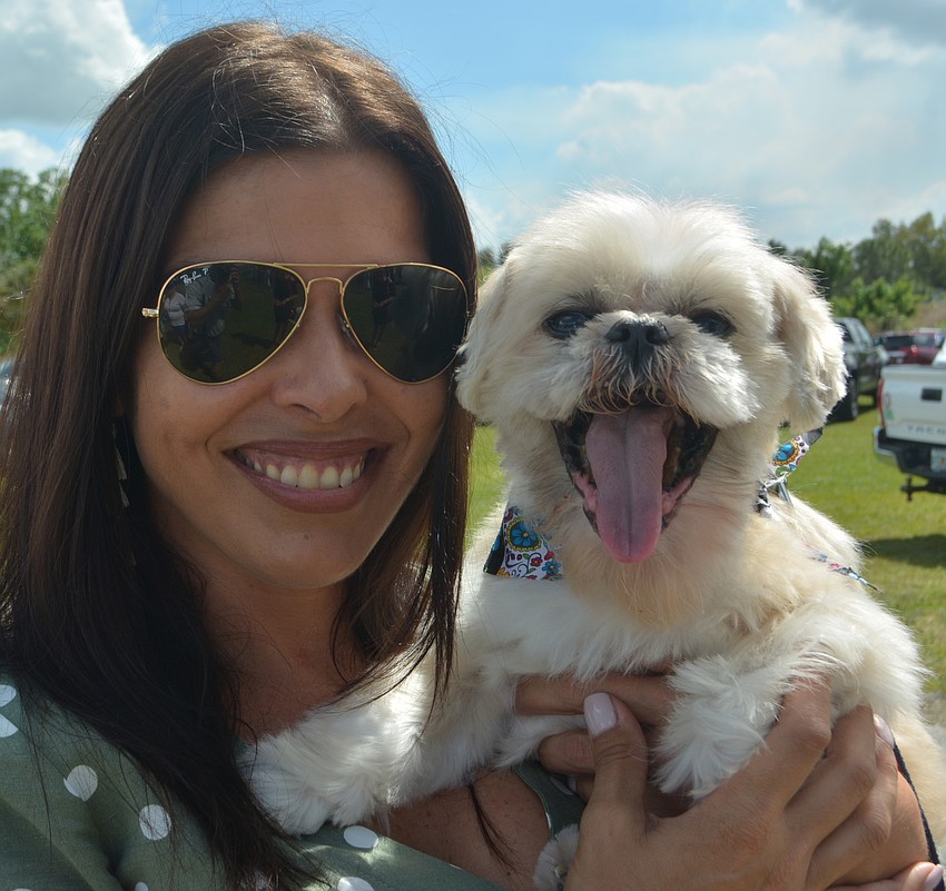Sarasota's Katy Carrigan and her rescue dog, Homer, enjoy the festivities at Ponies for Pups. Carrigan works for event sponsor Raymond James.