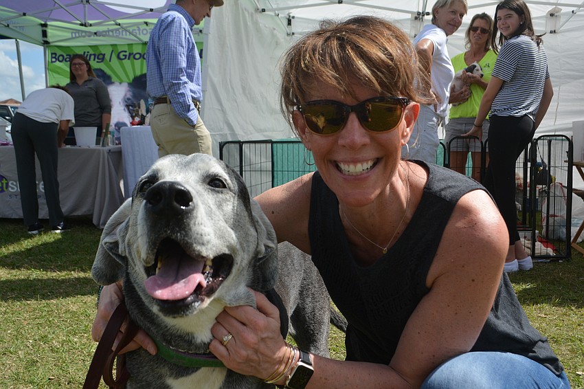 Bloomington, Ind.'s Laura Karcher, who is visiting her parents, Panther Ridge's Gary and Danielle Ulfers, holds Sam, a 7-year-old black lab-great Dane mix.