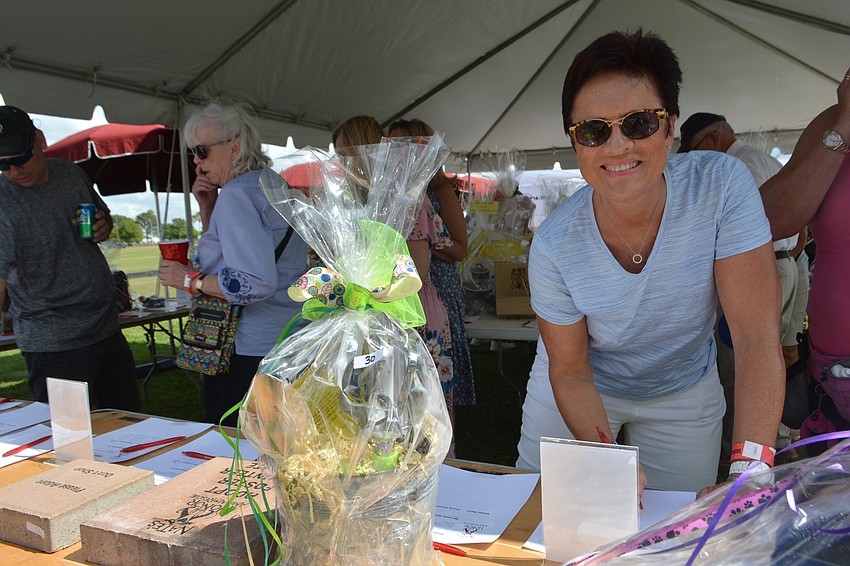 Mote Ranch's Martina Schlagwein makes a bid on a silent auction item.