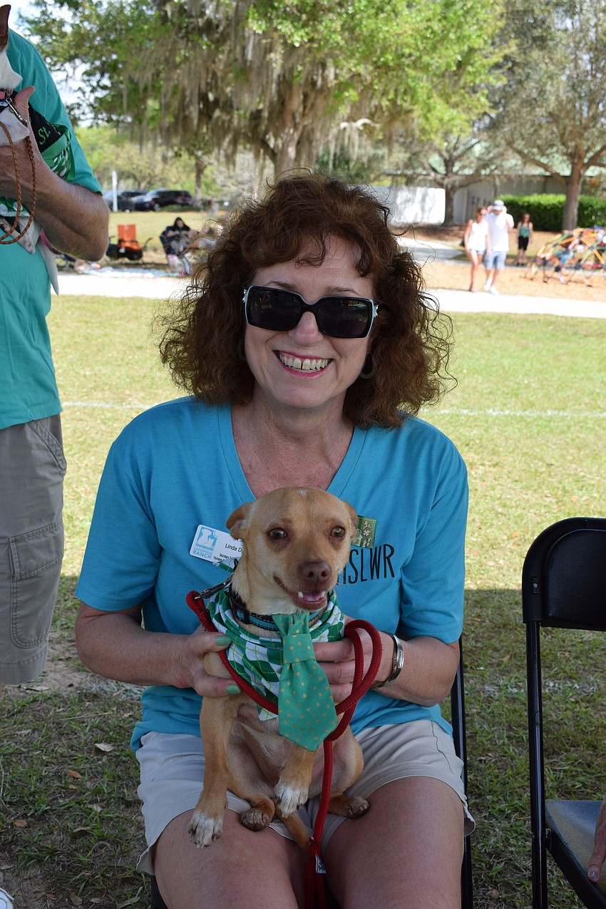 Linda Dirk, secretary and board member for the Humane Society  at Lakewood Ranch, holds a dog that's up for adoption, Tanner.