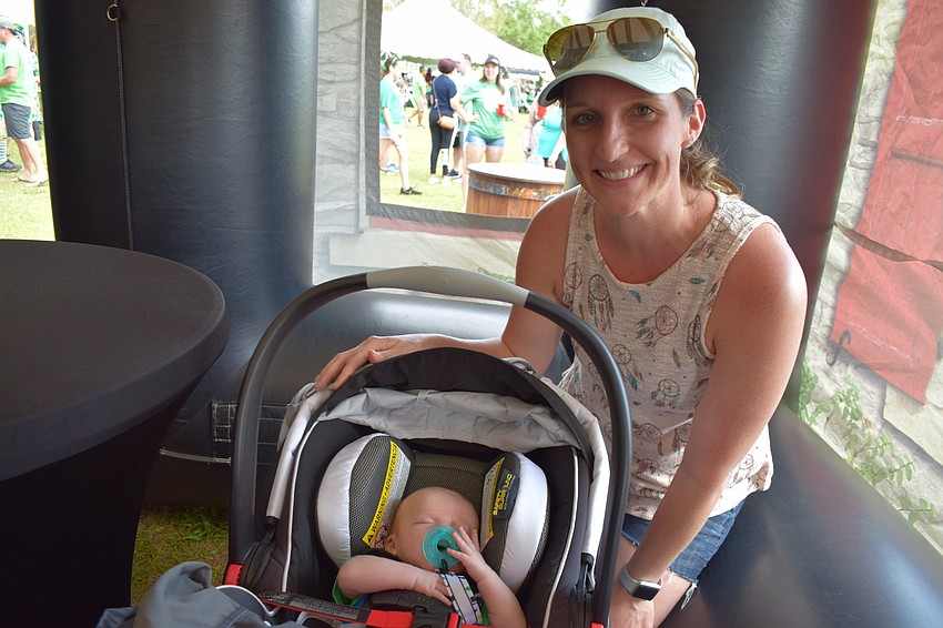 Niki Cox, of Panther Ridge, let her 6-week-old son Dylan enjoy the ride at the festival, though he seemed more interested in napping.