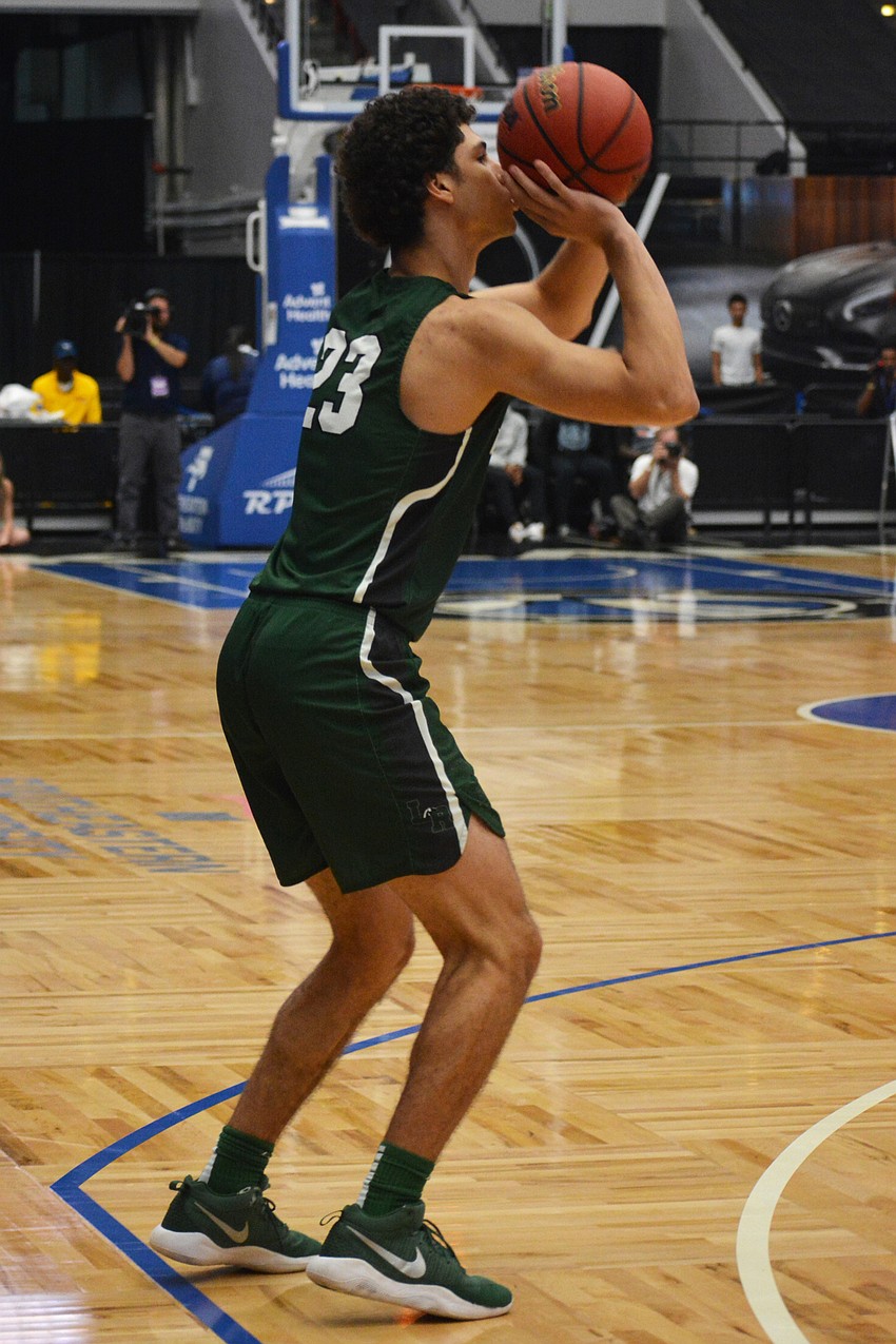 Junior guard Christian Shaneyfelt takes a 3-point shot from the corner. He finished with 12 points.