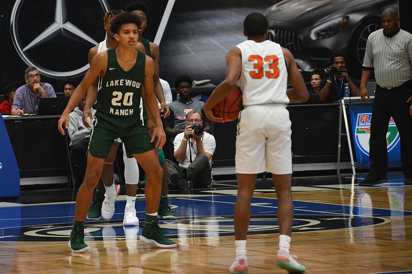 Junior guard Keon Buckley (20) keeps an eye on Blanche Ely junior guard Lamont Evans.