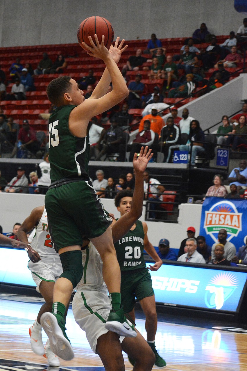 Junior guard Jaden Jones skies for a jumper against Blanche Ely.