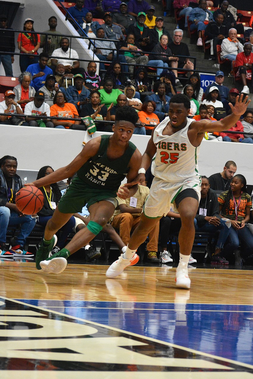 Senior forward Josh Young drives the baseline past Blanche Ely senior Lance Rainer.