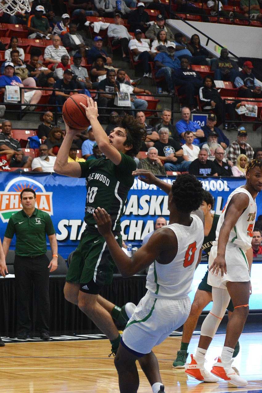 Junior guard Christian Perez skies for a layup against Blanche Ely. He finished with three points and four assists.