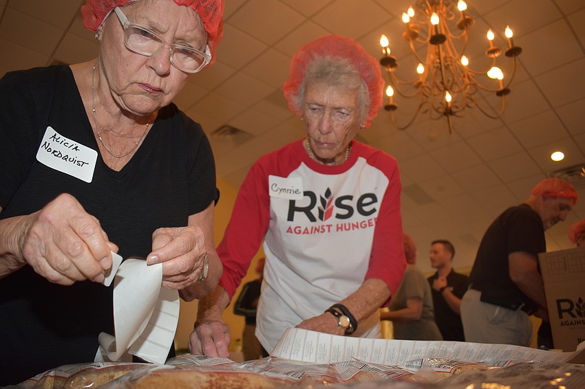 Alicia Nordquist and Cynthia Smyth have to count all of the bags before they get shipped off in the boxes to those in need.