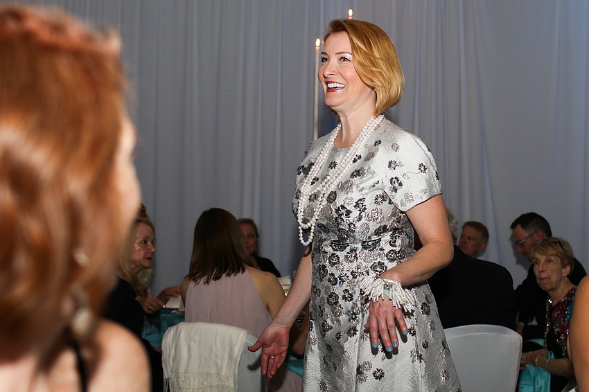 Emily Walsh models the pearls in the live auction.