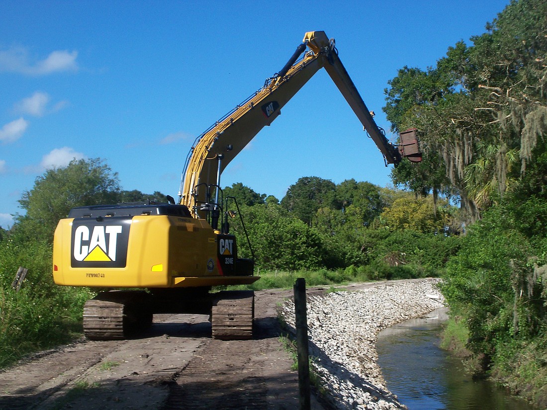 Crews mow on Buffalo Canal north of Moran Road in September 2013. Courtesy photo.
