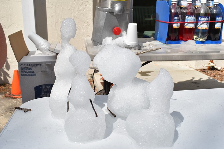 The volunteers doling out snow cones made little snowmen, despite the warm weather.