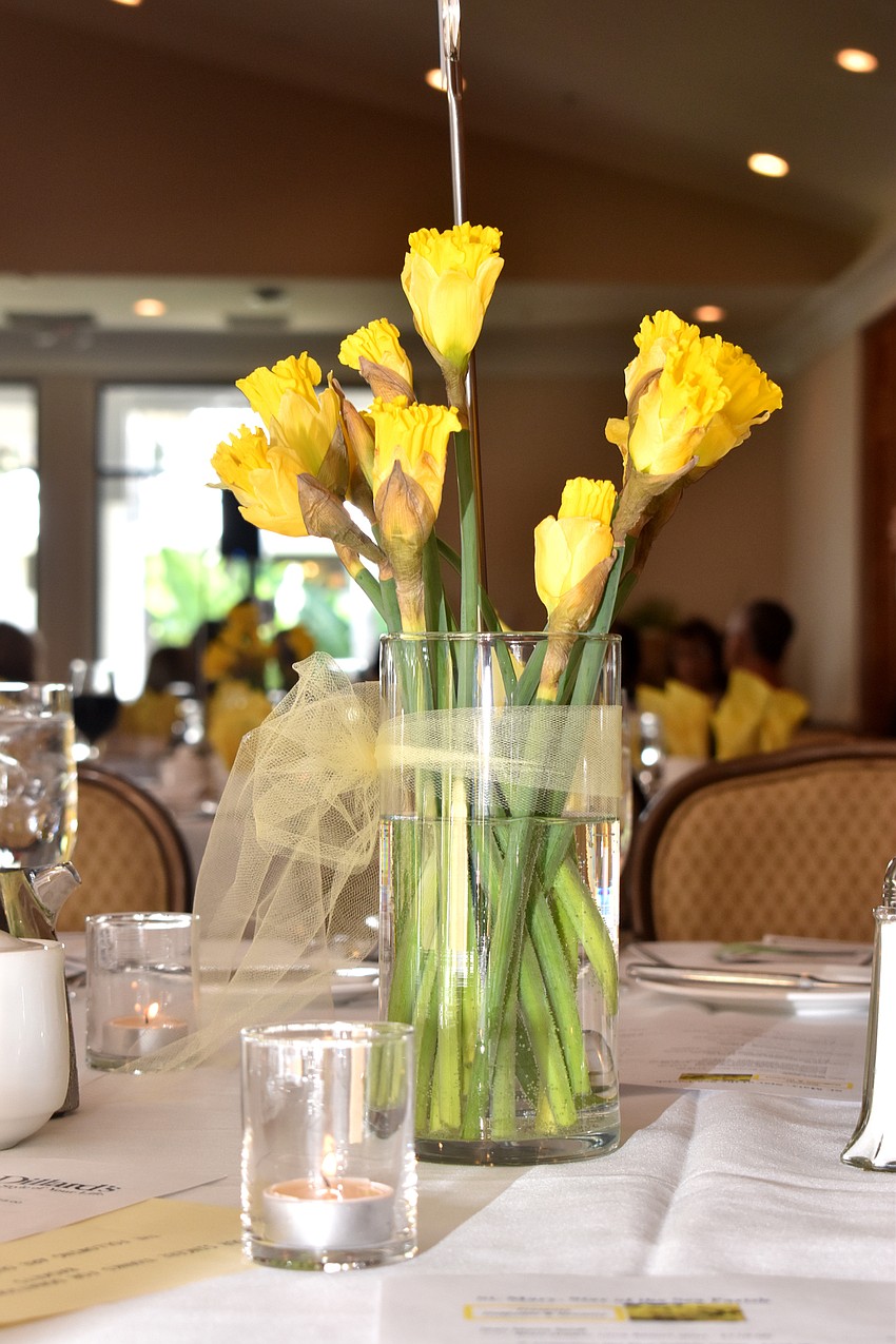 Daffodils decorated each of the tables in the room.
