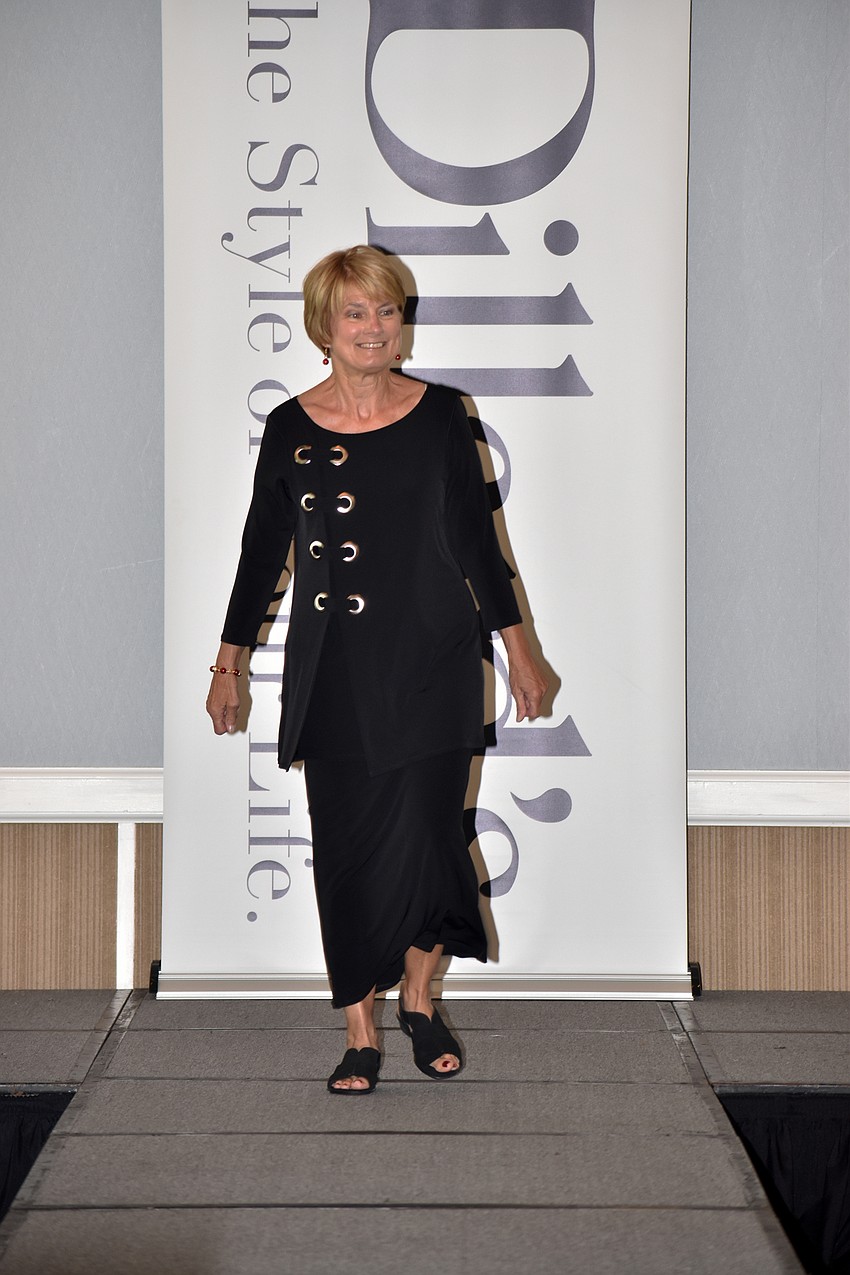 Linda Litwin models a black tunic on the runway.