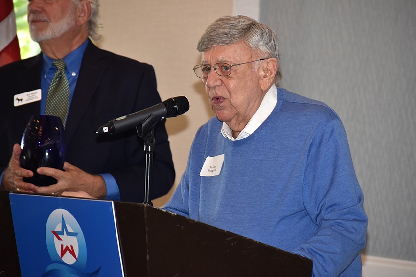 Murray Blueglass, a former club president, addresses the crowd after accepting his award.