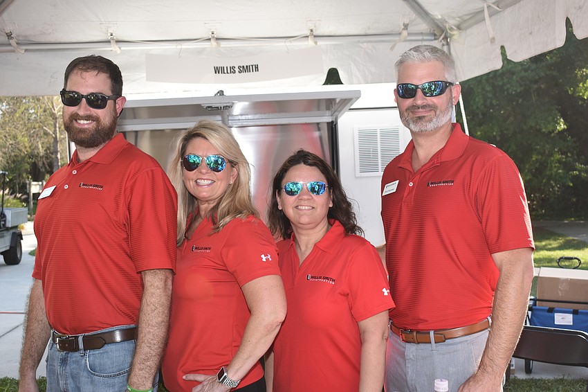 Rich Scherzer, Peggy Kronus, Ellen Snyder and Brett Raymaker from Willis Smith Construction served refreshments at the party.