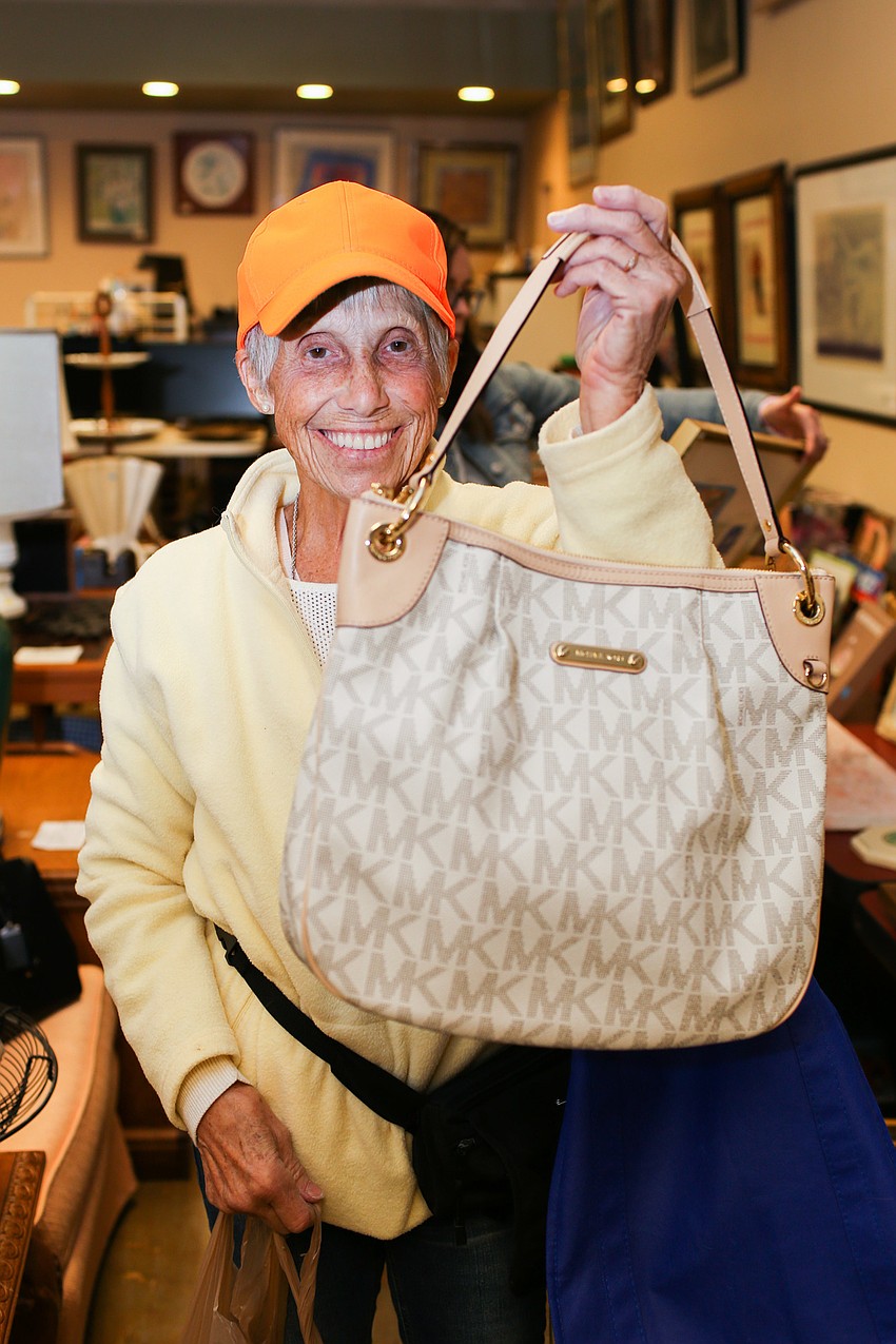 CJ Johnson won a Michael Kors purse in the Fabulous Finds raffle drawing.