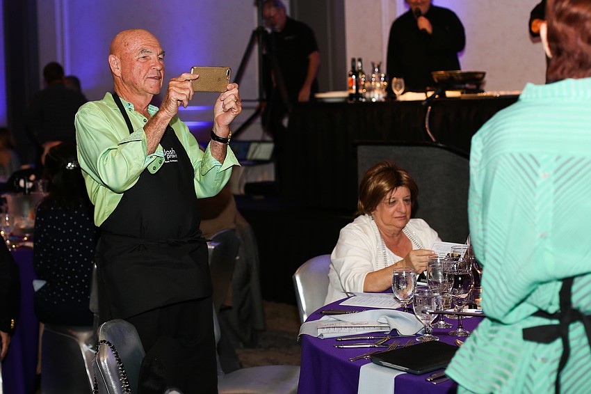 Ken Abt takes a photo of his table.