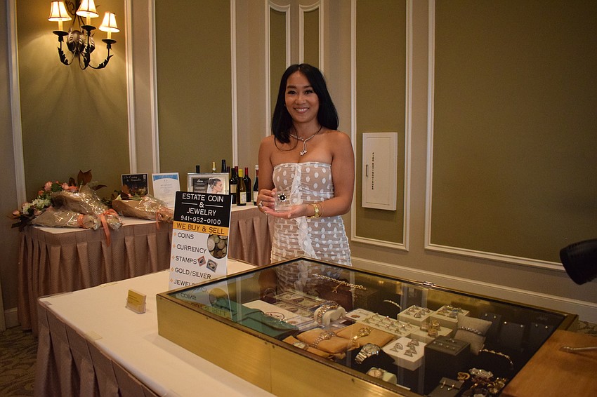 Jerica Rogers, of Estate Coin and Jewelry Galleria, holds the diamond her business provided for the event.