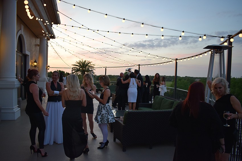 Guests mingled in the outdoor space after sunset.