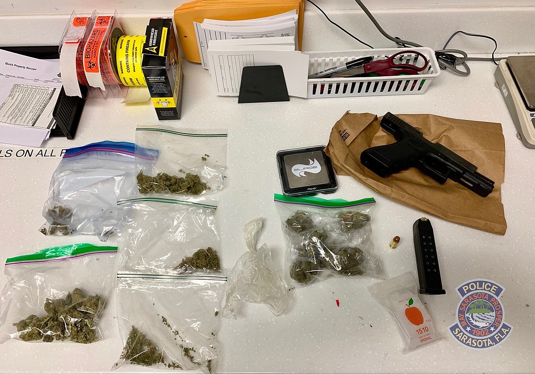 Officers seized a firearm, ammunition, marijuana and cocaine in addition to a digital scale.