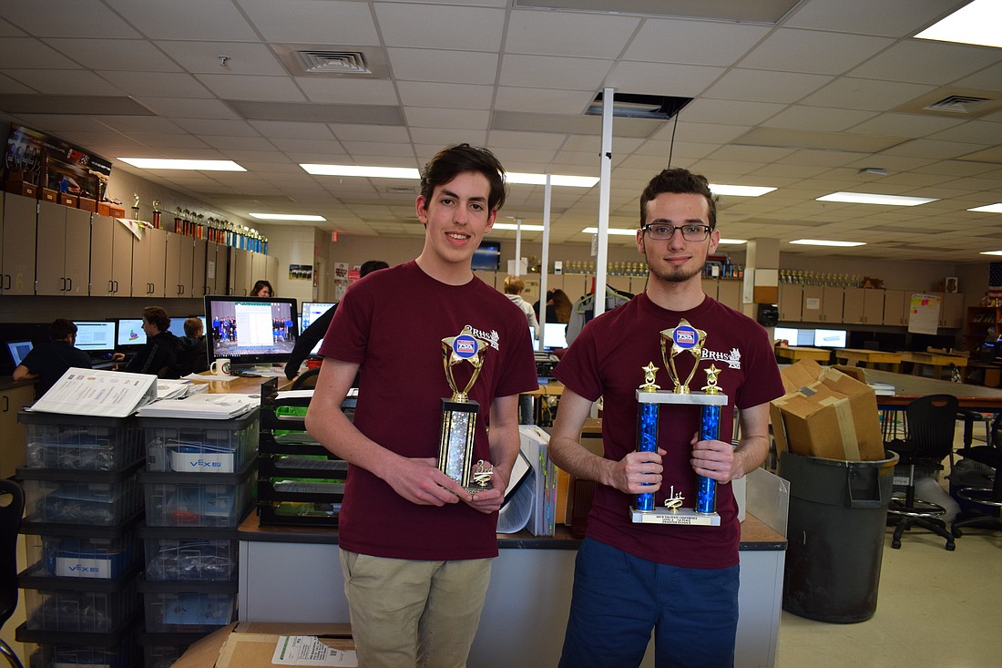 Liam Wilford and Brandon Schwartz hold their trophies.