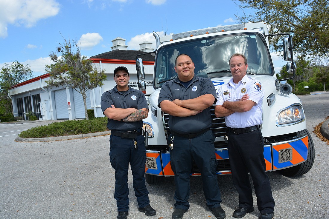 Manatee County Emergency Services Paramedics Andrew Garcia and Paul Lauffer pose with District Chief Mark Laraway at the future EMS station, formerly home to the American Red Cross.
