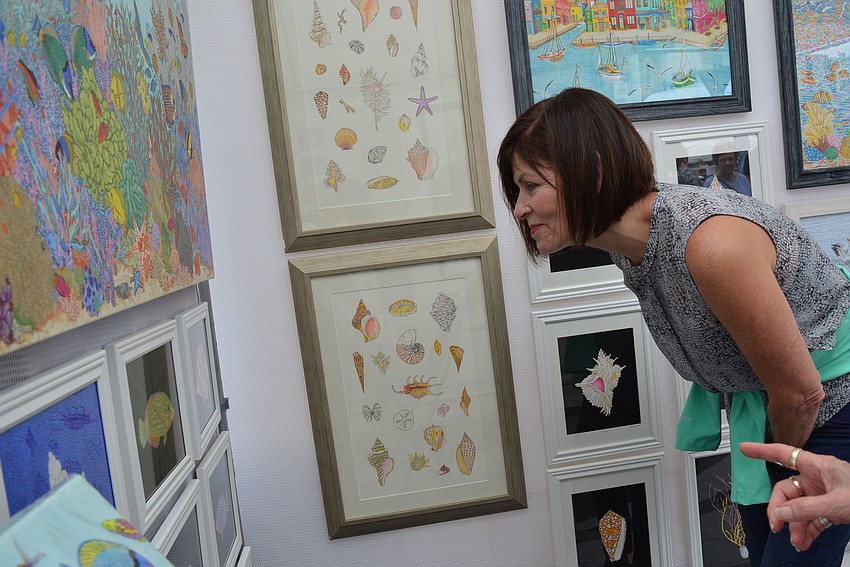 Lakewood Ranch's Yvetter Morgan admires the work of artist Nancy Connors, who does inkspot drawings.