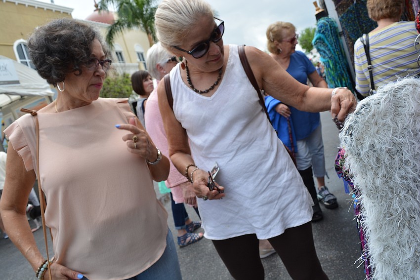 East County residents Maria Calhoun and Lisa Nieves check out some handmade scarves.