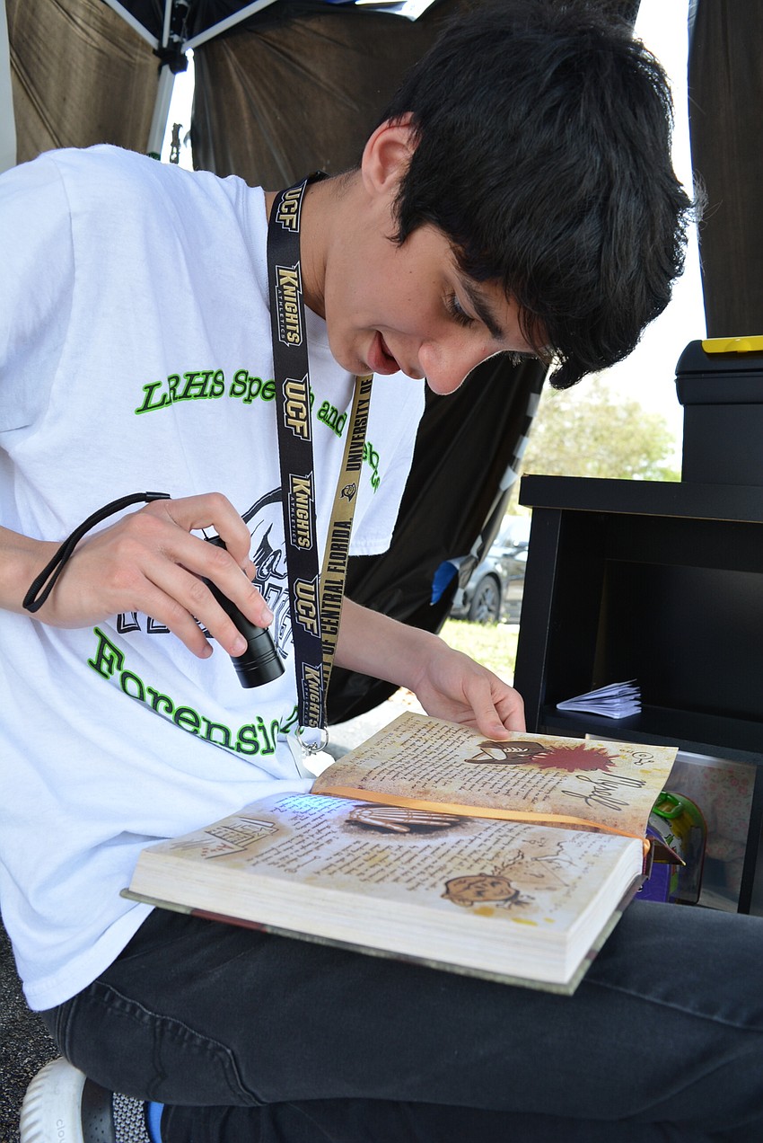 Sophomore Skyler Holmes, who is on the Speech and Debate Club, tries out the Escape Room offered by the Mustangs for Kids Club.