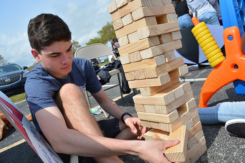 Technology Student Association member Jake Hanson plays giant Jenga with friend Katie Hartley as they wait for others to come play.