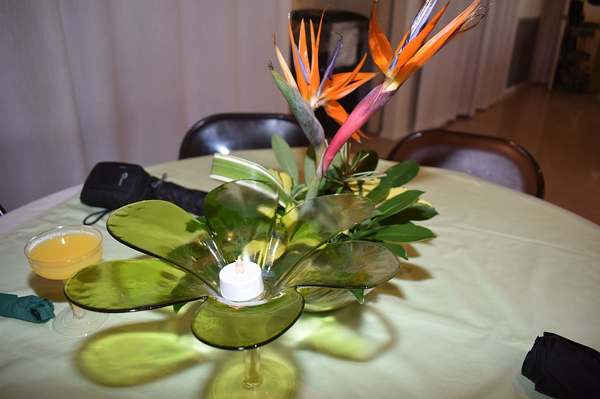 The centerpieces included smaller flower and green candle holders.